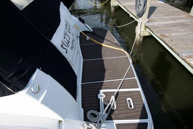 Slide: The Image of 2011 Cruisers Yachts 360 Express docked, featuring a sleek deck and mooring lines. - 2