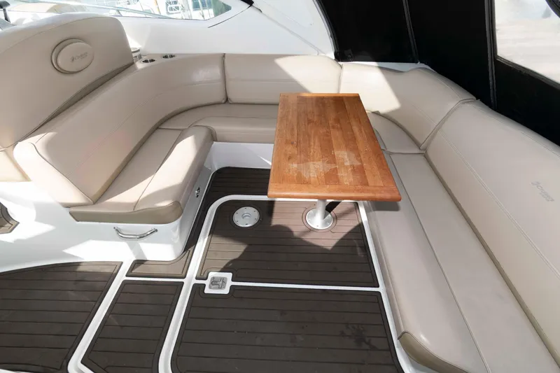 Slide: The Image of 2011 Cruisers Yachts 360 Express interior with beige seating and wooden table. - 9