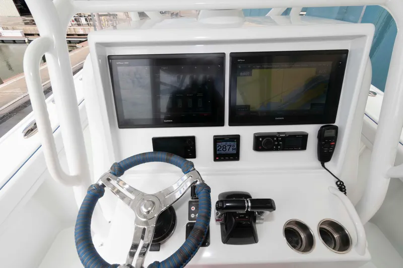 Slide: The Image of 2018 Yellowfin 32 Offshore helm with dual Garmin displays and marine controls. - 11