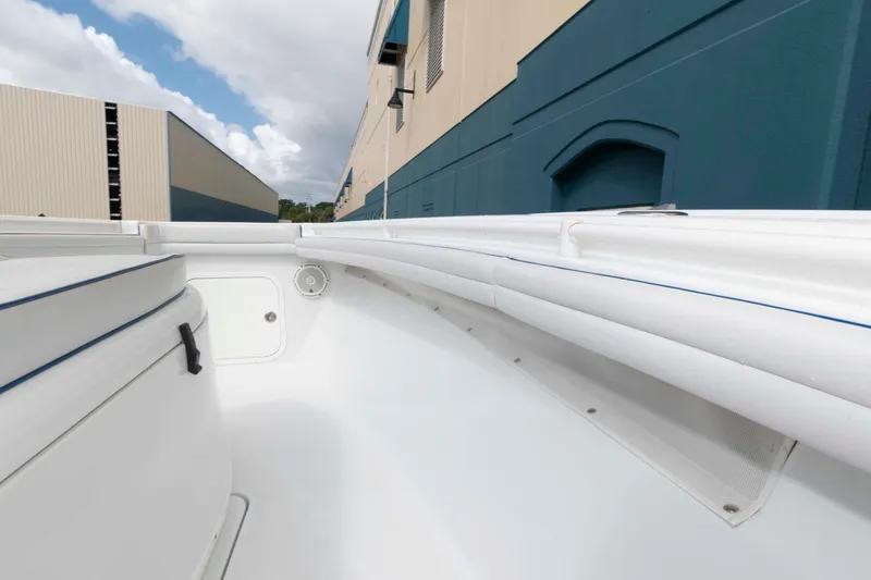 Slide: The Image of 2018 Yellowfin 32 Offshore boat interior with white seating and storage compartments. - 15