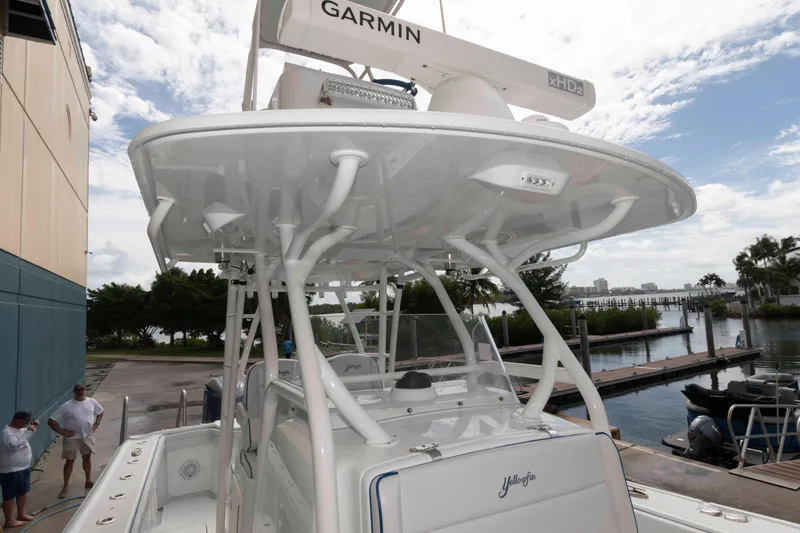 Slide: The Image of 2018 Yellowfin 32 Offshore boat with Garmin radar, docked near marina. - 18
