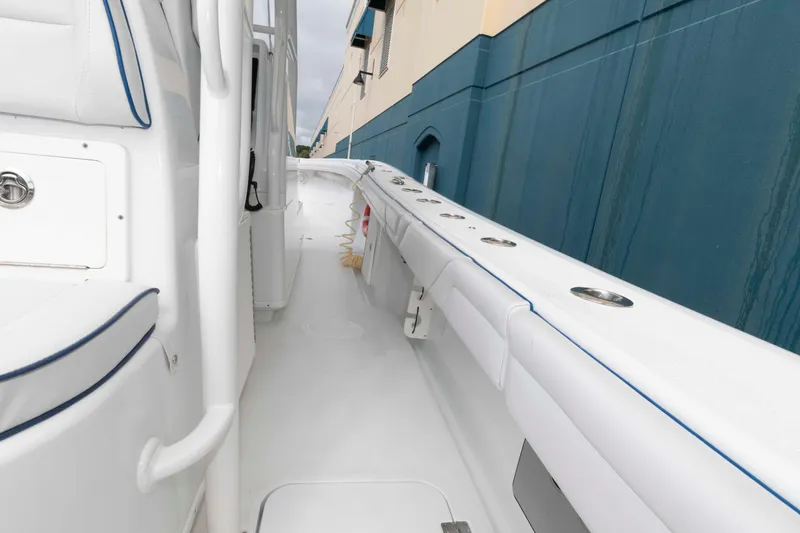Slide: The Image of 2018 Yellowfin 32 Offshore boat deck with white seating and blue accents. - 22