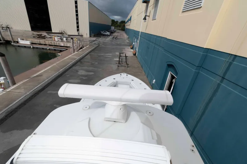 Slide: The Image of 2018 Yellowfin 32 Offshore boat docked near industrial buildings. - 24