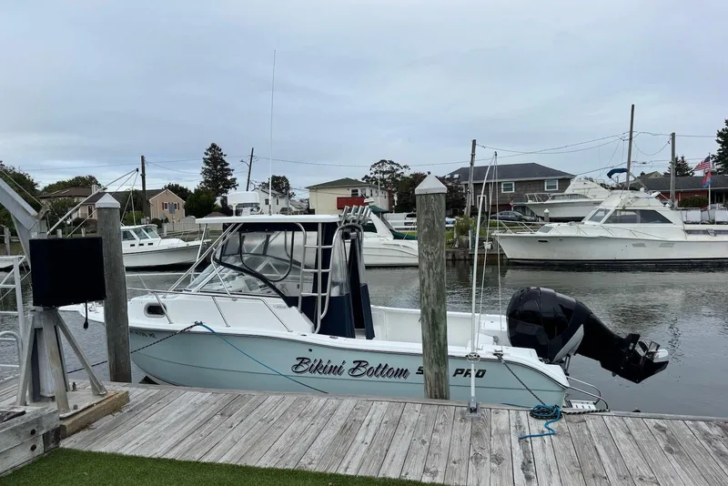 The Image of 2006 Sea Pro 238 Walk Around boat docked at a marina, overcast sky. - 0
