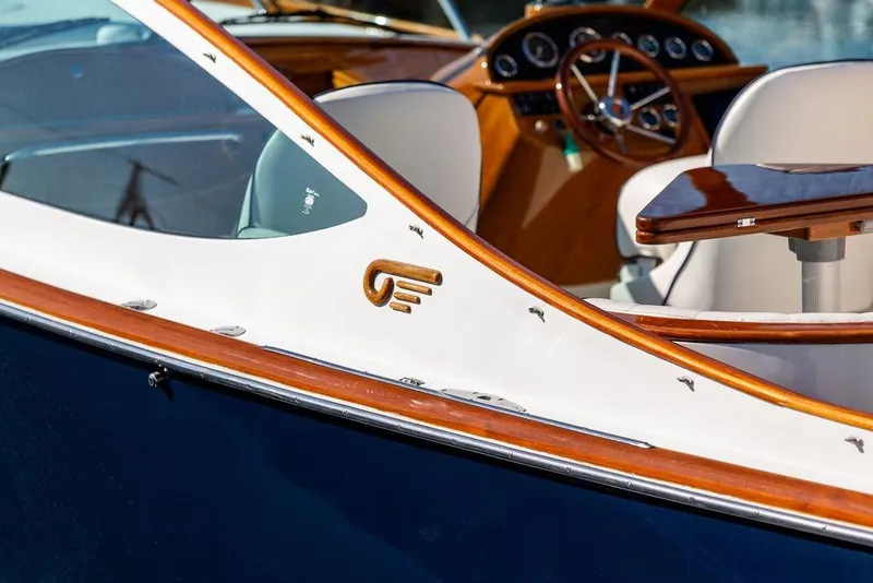 Slide: The Image of 2003 Hinckley T29R boat interior with wooden accents and steering wheel. - 31