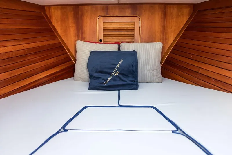 Slide: The Image of Cozy cabin interior of 2003 Hinckley T29R with wooden paneling and cushions. - 11