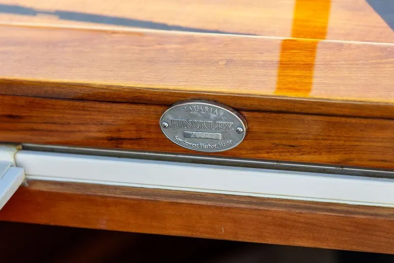 Slide: The Image of Polished wood detail of 2003 Hinckley T29R boat with engraved metal nameplate. - 12