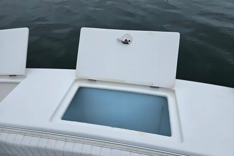 Slide: The Image of Open storage compartment on 2005 Topaz 24 Silverhawk boat, near water surface. - 14