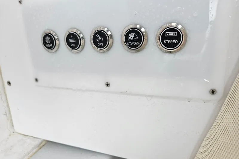Slide: The Image of Control panel of a 2005 Topaz 24 Silverhawk boat with radar, VHF, GPS, network, and stereo buttons. - 16