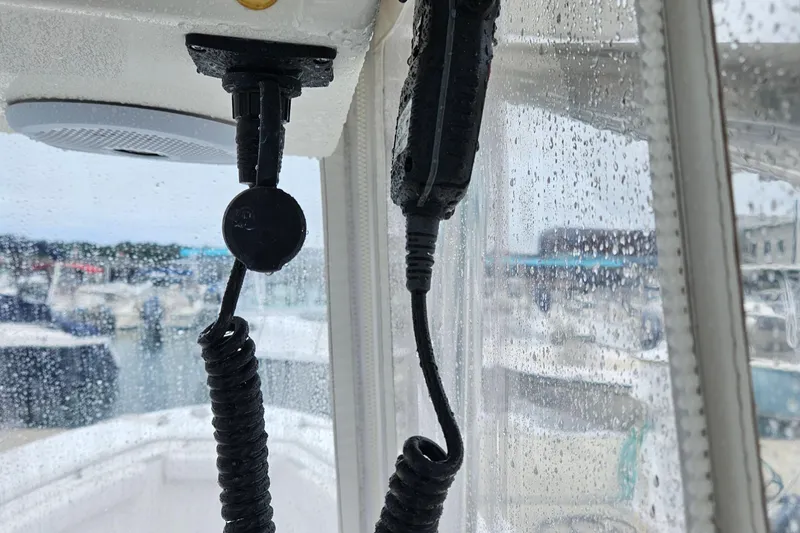 Slide: The Image of Close-up of a 2005 Topaz 24 Silverhawk boat interior with wet windows and coiled cables. - 17