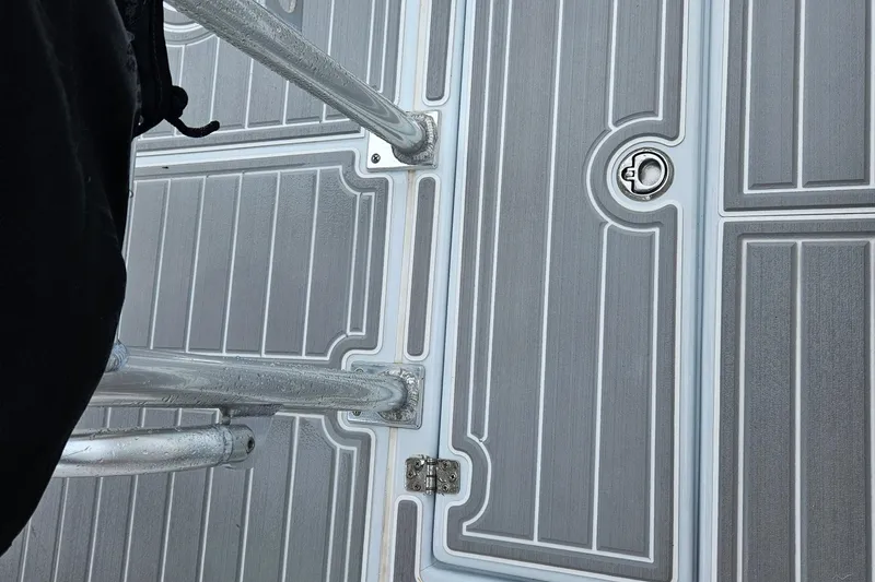 Slide: The Image of Deck of 2005 Topaz 24 Silverhawk boat with metal railing and hatch. - 20