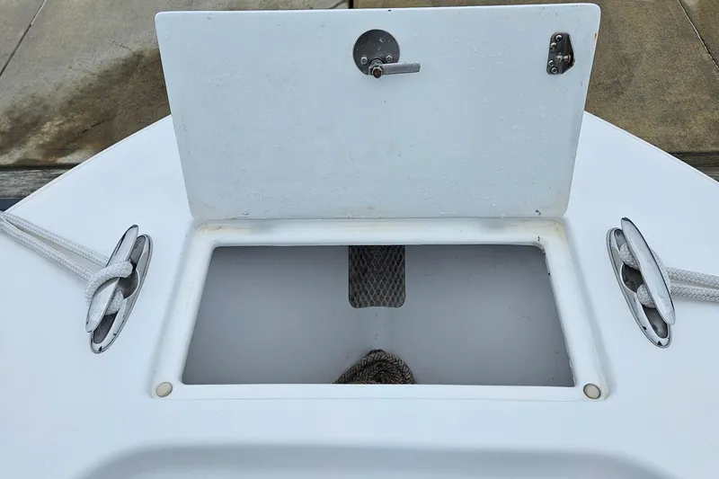 Slide: The Image of Open anchor locker on 2005 Topaz 24 Silverhawk boat with cleats and ropes. - 21
