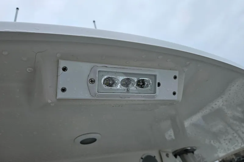 Slide: The Image of LED light fixture on a 2005 Topaz 24 Silverhawk boat under a cloudy sky. - 22