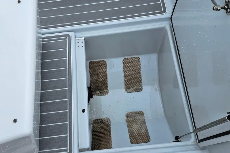 Slide: The Image of 2005 Topaz 24 Silverhawk boat deck with storage compartment and non-slip flooring. - 26