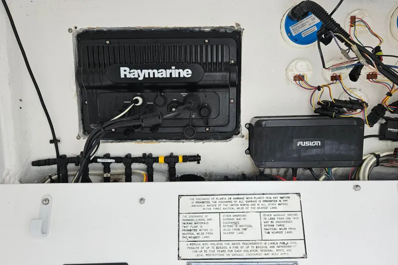 Slide: The Image of 2005 Topaz 24 Silverhawk boat electronics panel with Raymarine and Fusion systems. - 29