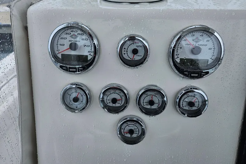 Slide: The Image of Dashboard of a 2005 Topaz 24 Silverhawk boat with various gauges and controls. - 30