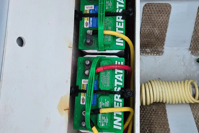 Slide: The Image of Batteries in a 2005 Topaz 24 Silverhawk boat with Interstate branding and colored cables. - 31
