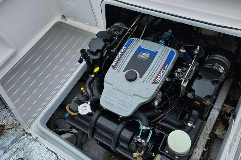 Slide: The Image of Engine compartment of a 2005 Topaz 24 Silverhawk boat, featuring a MerCruiser 350 MAG engine. - 36