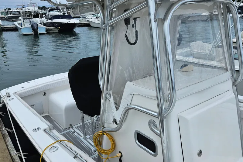 Slide: The Image of 2005 Topaz 24 Silverhawk boat docked in marina, featuring sleek design and modern equipment. - 5