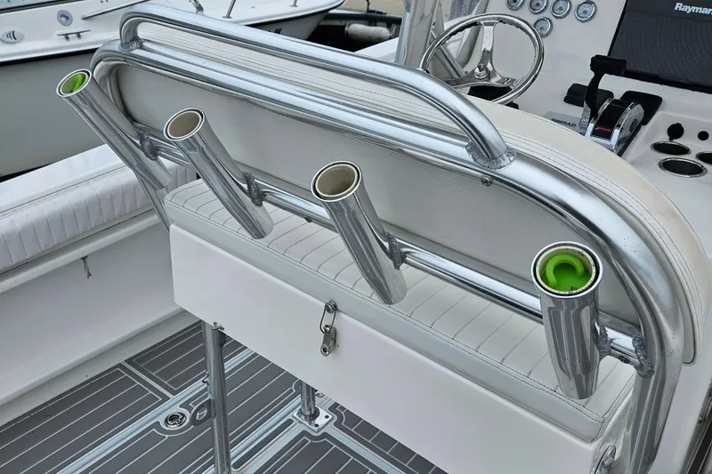 Slide: The Image of 2005 Topaz 24 Silverhawk boat interior with rod holders and steering console. - 7