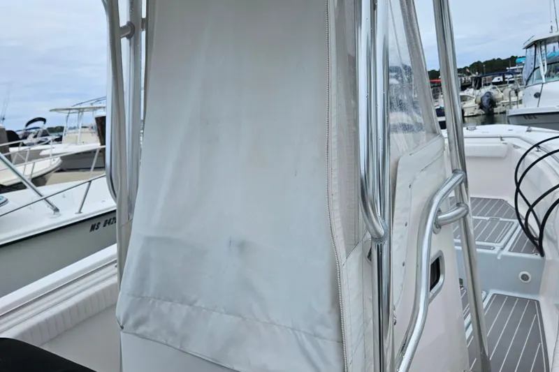 Slide: The Image of 2005 Topaz 24 Silverhawk boat with covered console at marina. - 9