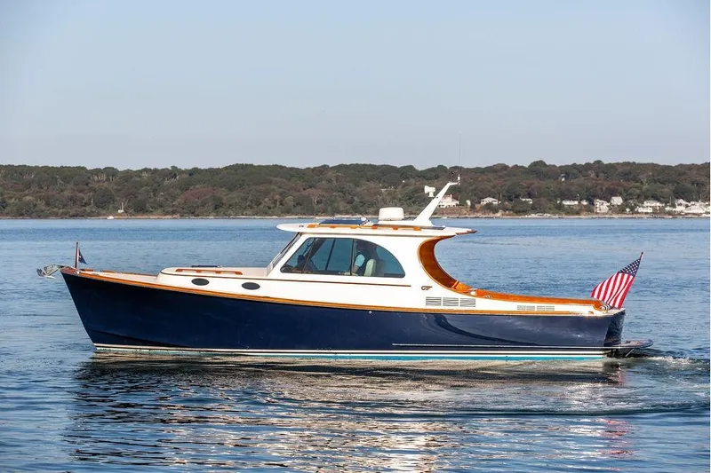 Slide: The Image of 2018 Hinckley Picnic Boat MKIII cruising on calm waters, certified pre-owned. - 0