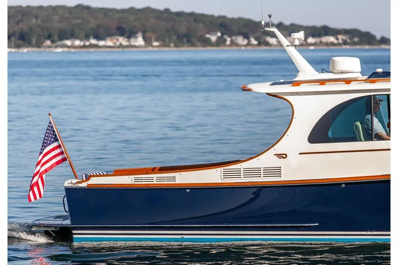 Slide: The Image of 2017 Hinckley Picnic Boat MKIII cruising with American flag on calm waters. - 10