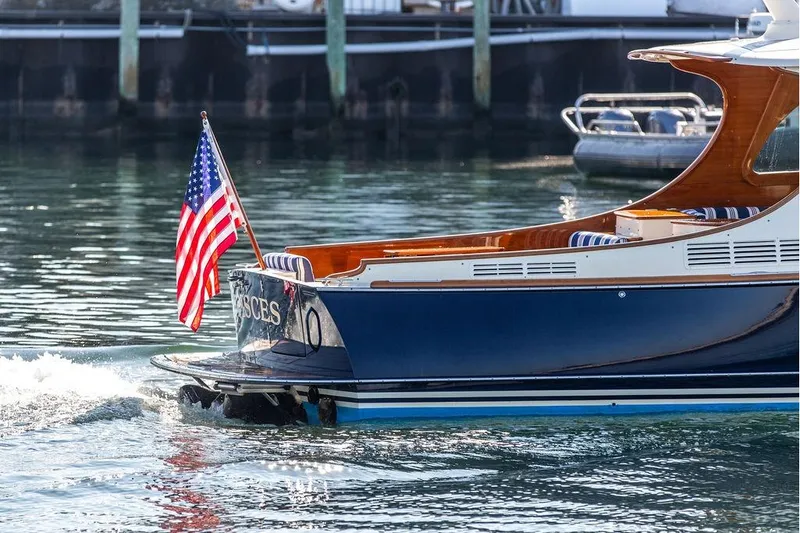 Slide: The Image of 2017 Hinckley Picnic Boat MKIII cruising with American flag on water. - 11
