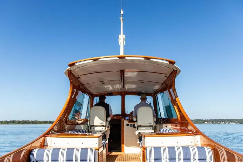 Slide: The Image of 2017 Hinckley Picnic Boat MKIII cruising on calm waters under clear blue sky. - 14