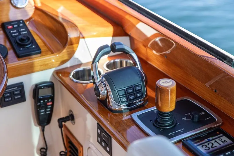 Slide: The Image of 2017 Hinckley Picnic Boat MKIII helm with controls and wooden accents. - 28