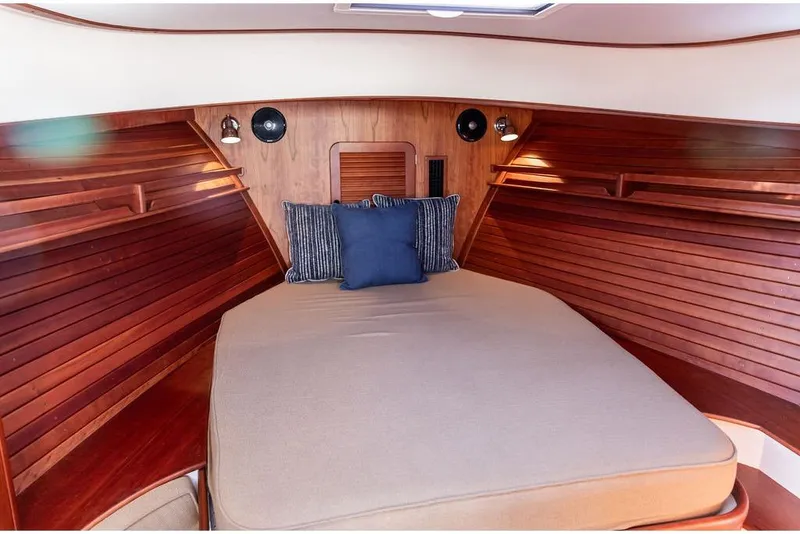 Slide: The Image of Cozy cabin interior of 2017 Hinckley Picnic Boat MKIII with wooden finish and cushions. - 32