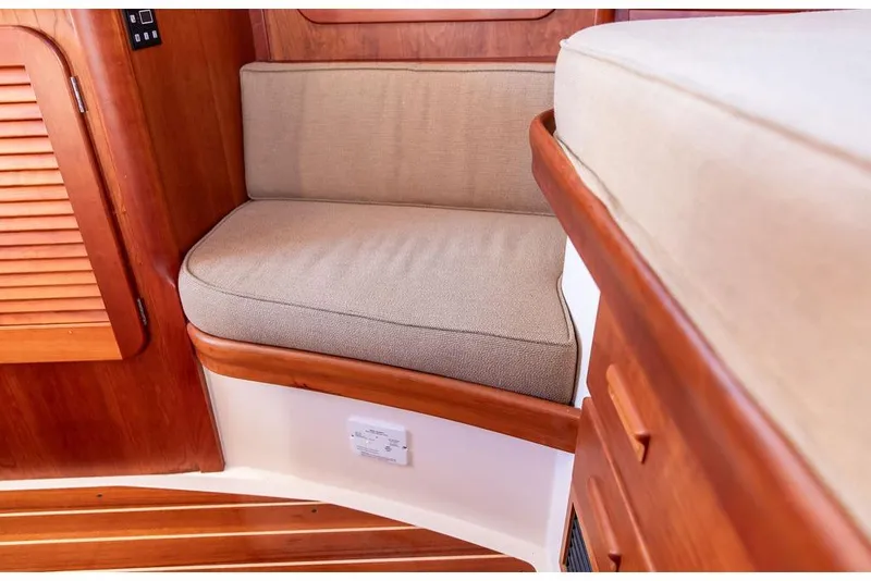 Slide: The Image of Interior seating of 2017 Hinckley Picnic Boat MKIII with wooden finish and beige cushions. - 33
