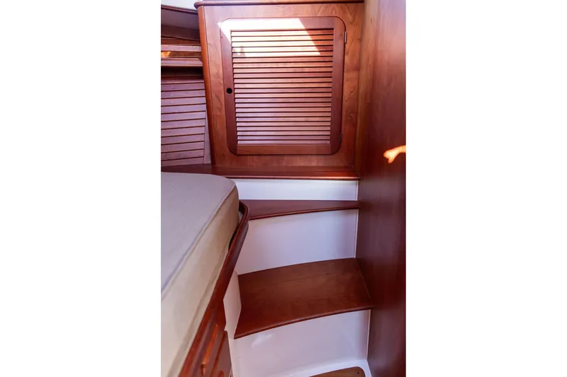 Slide: The Image of Interior of 2017 Hinckley Picnic Boat MKIII with wooden cabinetry and steps. - 34