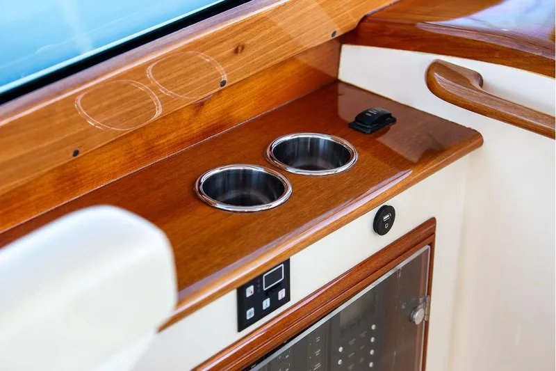 Slide: The Image of 2017 Hinckley Picnic Boat MKIII interior with wooden finish and cup holders. - 41