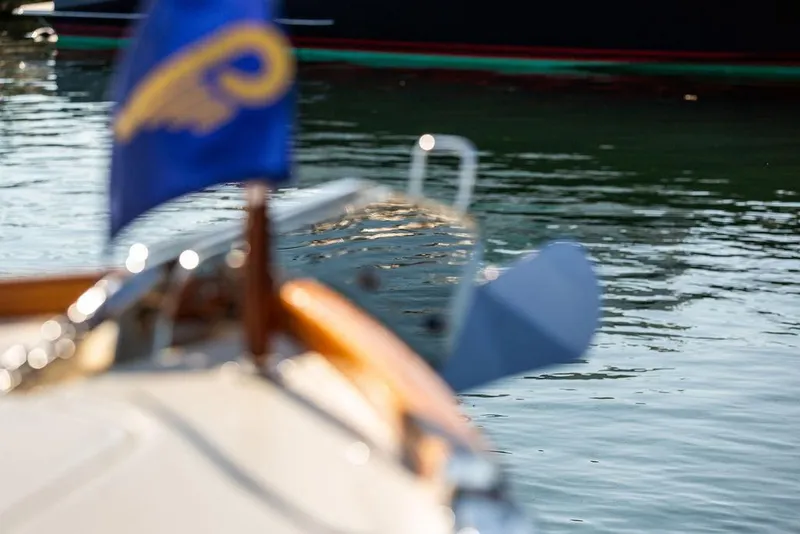 Slide: The Image of 2017 Hinckley Picnic Boat MKIII on water, with blurred flag in foreground. - 45