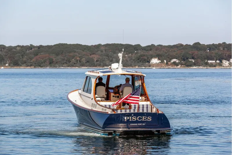 Slide: The Image of 2017 Hinckley Picnic Boat MKIII cruising on calm waters with American flag. - 5