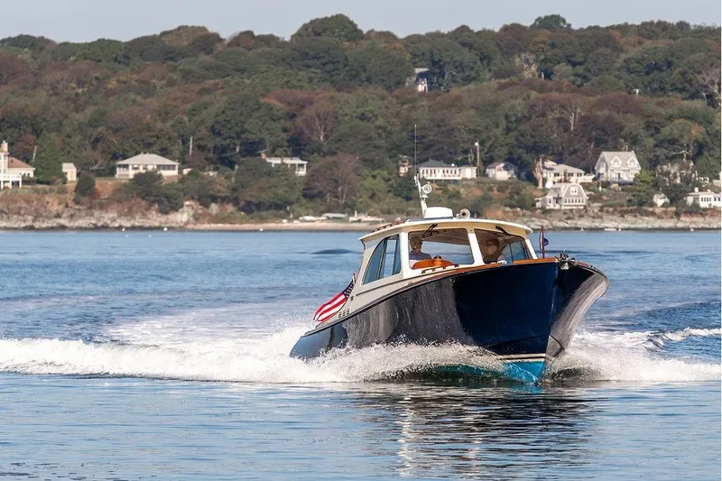 Slide: The Image of 2017 Hinckley Picnic Boat MKIII cruising on a scenic coastal waterway. - 7