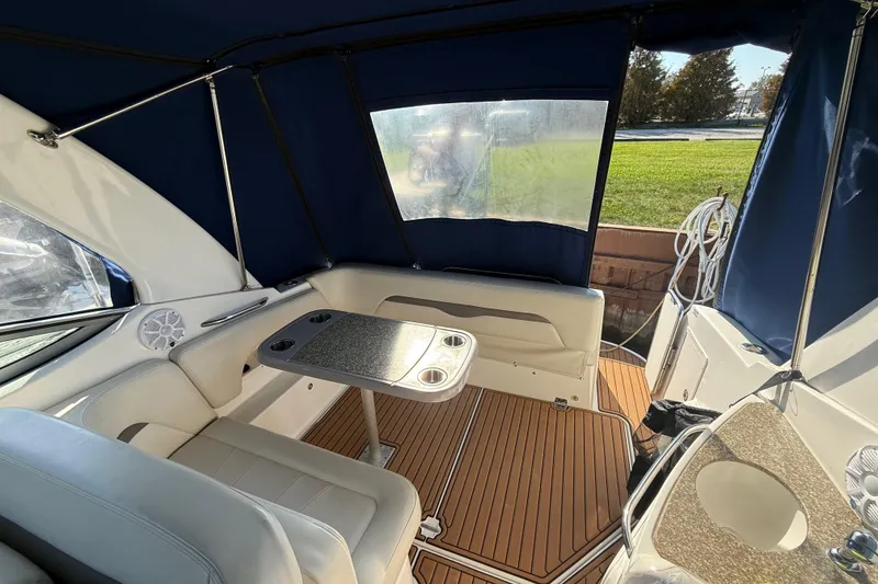 Slide: The Image of 2009 Chaparral Signature 280 boat interior with seating, table, and blue canopy. - 10
