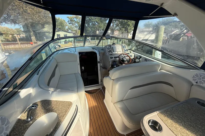 Slide: The Image of 2009 Chaparral Signature 280 boat interior with helm, seating, and wood flooring. - 11