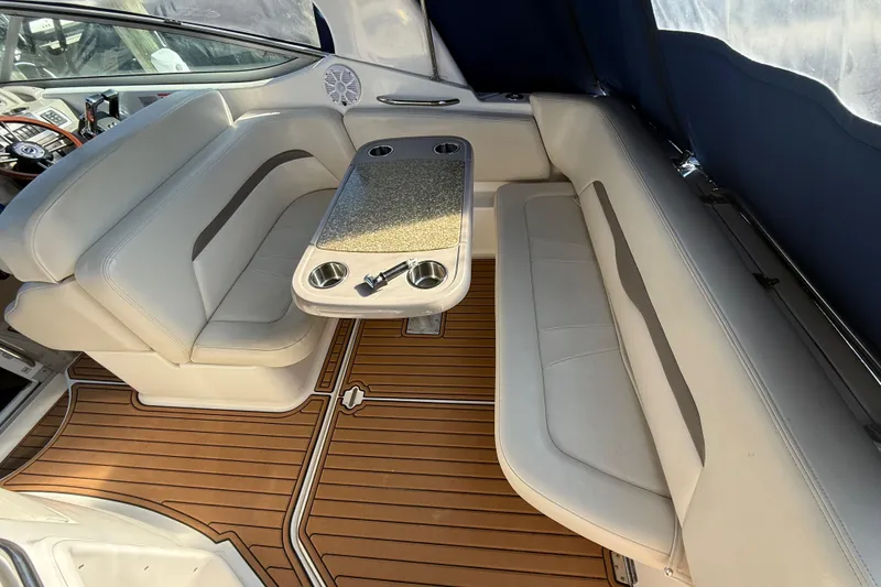 Slide: The Image of 2009 Chaparral Signature 280 interior with seating, table, and wood-style flooring. - 12