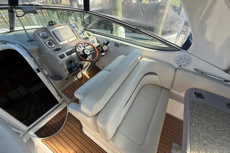 Slide: The Image of 2009 Chaparral Signature 280 boat interior with helm, seating, and wood flooring. - 14