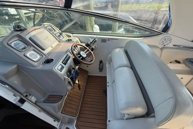 Slide: The Image of 2009 Chaparral Signature 280 boat interior with helm, steering wheel, and seating. - 15