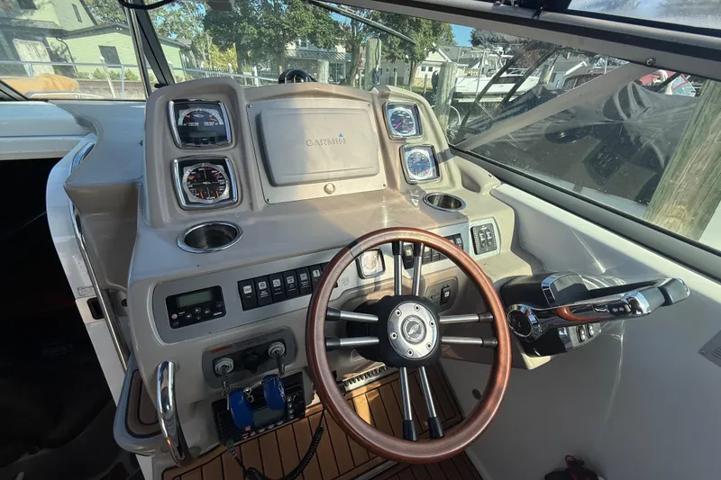 Slide: The Image of 2009 Chaparral Signature 280 boat dashboard with Garmin navigation and wooden steering wheel. - 16