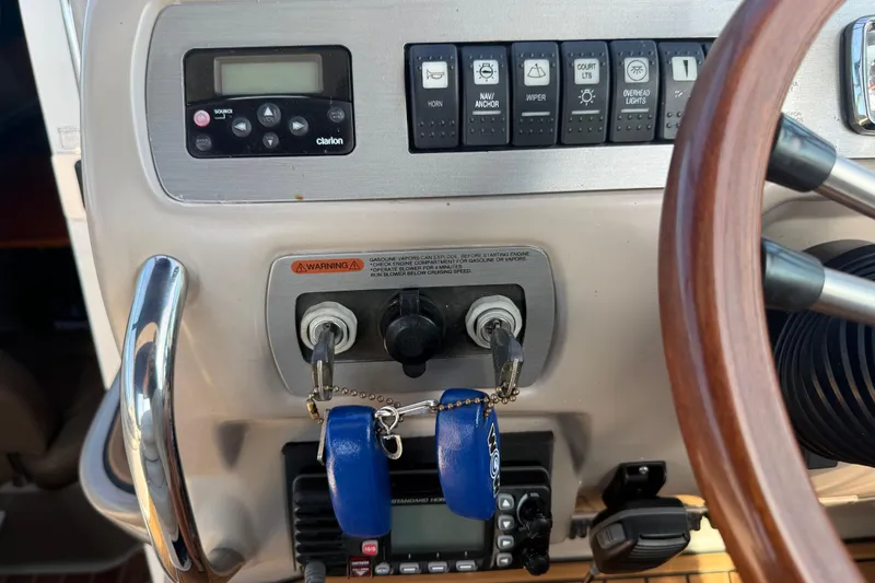 Slide: The Image of Control panel of a 2009 Chaparral Signature 280 boat with steering wheel and ignition keys. - 19