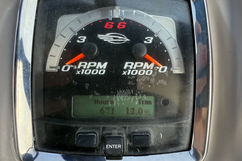 Slide: The Image of Close-up of 2009 Chaparral Signature 280 RPM gauge showing 671 hours and 12% trim. - 21