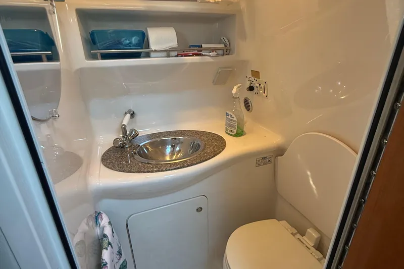 Slide: The Image of 2009 Chaparral Signature 280 bathroom with sink, toilet, and storage shelves. - 24