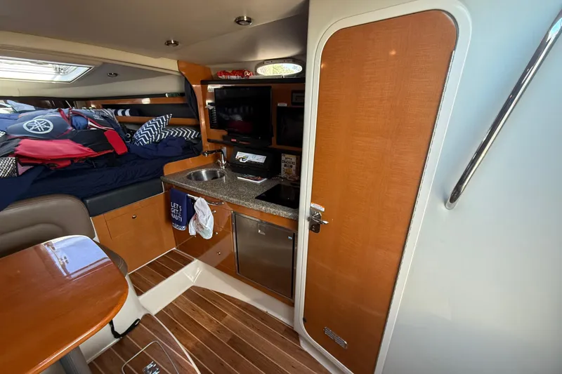 Slide: The Image of Interior of 2009 Chaparral Signature 280 boat with kitchenette and sleeping area. - 26