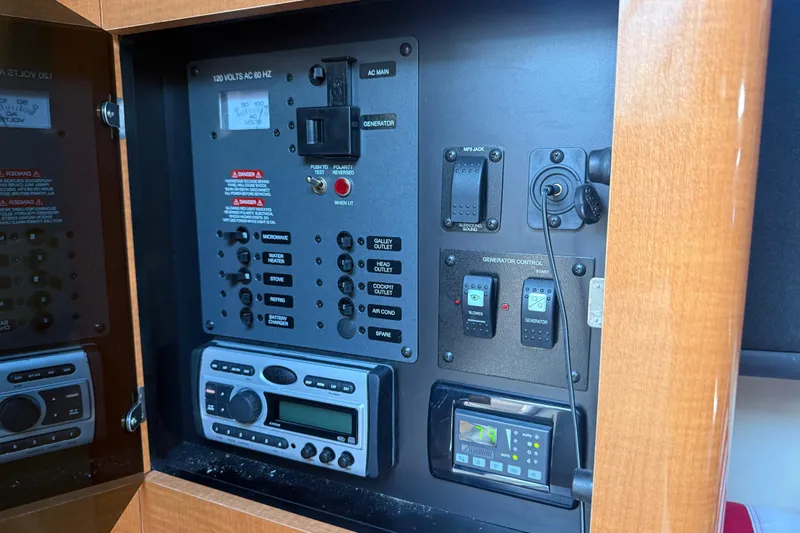 Slide: The Image of Control panel of a 2009 Chaparral Signature 280 boat, featuring various switches and displays. - 27