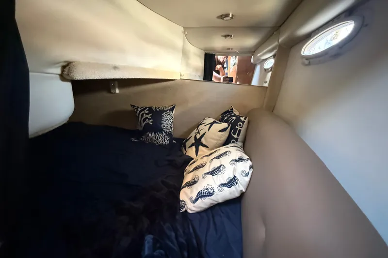 Slide: The Image of Interior cabin of 2009 Chaparral Signature 280 with cozy bedding and decorative pillows. - 37