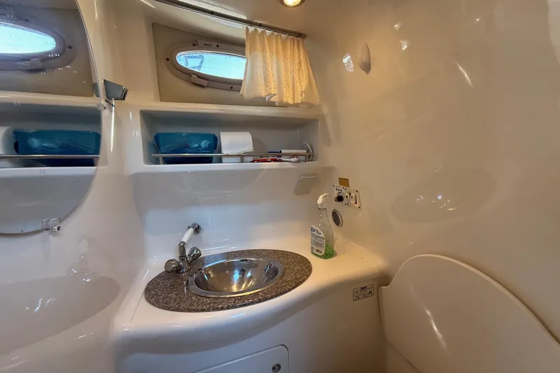 Slide: The Image of 2009 Chaparral Signature 280 bathroom with sink, mirror, and storage shelves. - 38